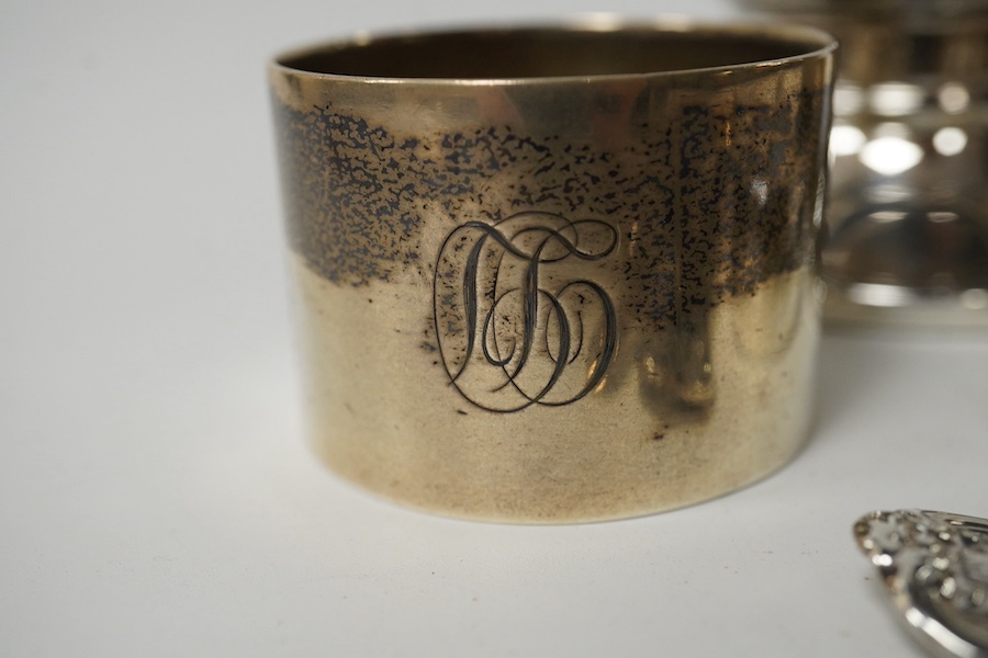 A modern silver capstan inkwell, two silver napkin rings and five items of silver cutlery including a pair of William IV sugar tongs. Condition - fair to good
